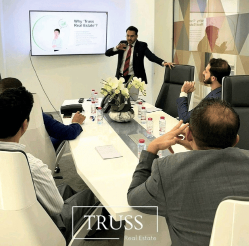 Mohamad Aftab, CEO of Truss Real Estate, presents the latest market trends to his team in their Dubai office conference room.